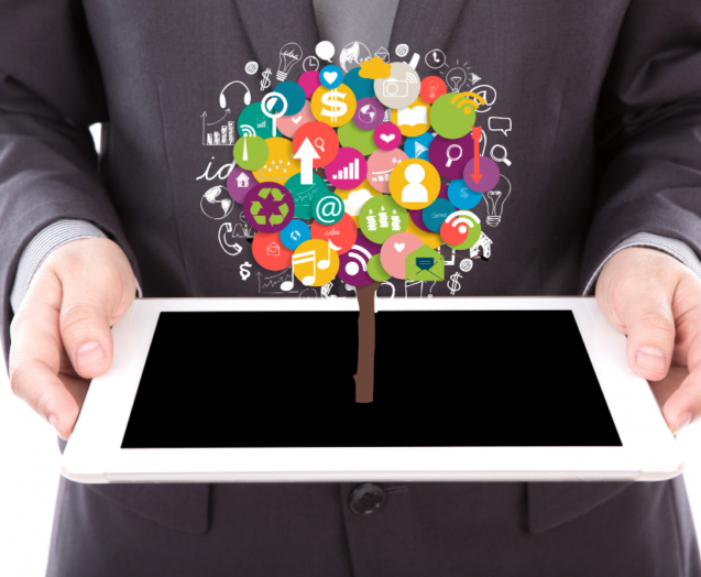 businessman-holding-tablet-with-colorful-icons of different marketing platforms